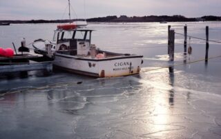 Motorboat Cigana at WHYC dock on frozen Great Harbor